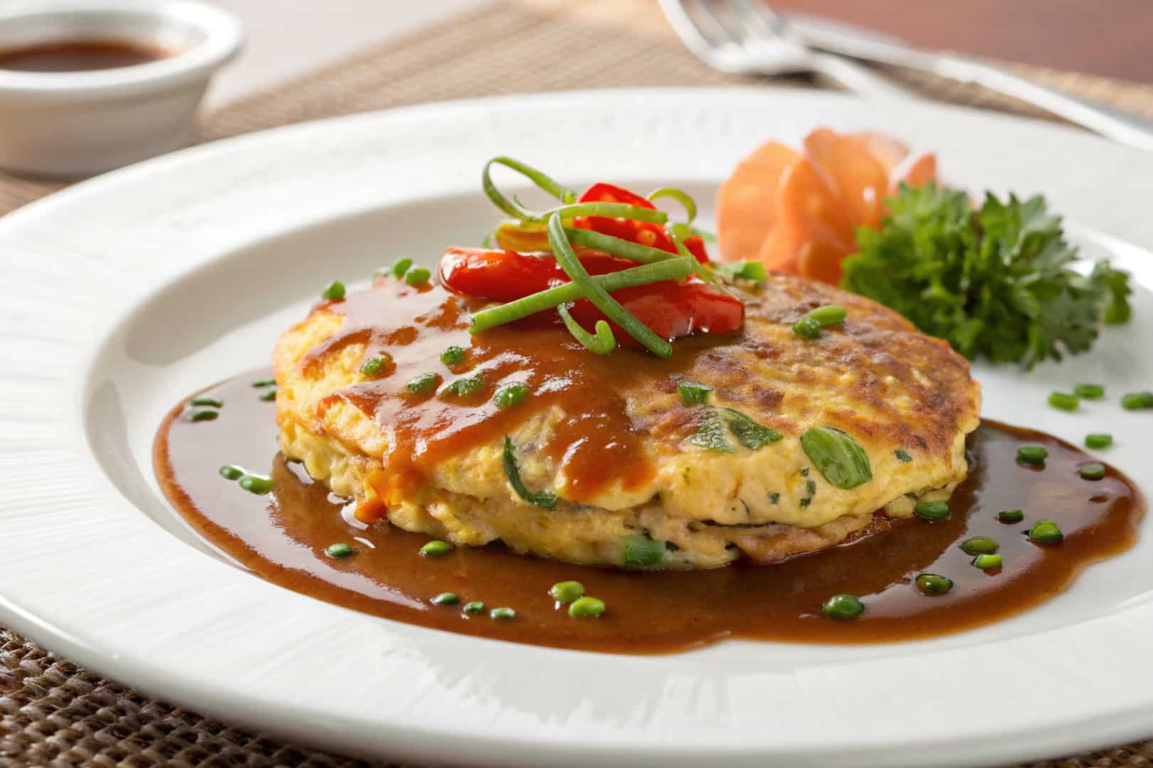 Egg foo young with gravy featured dish plated